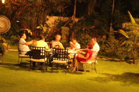 A table of guests on the lawn.